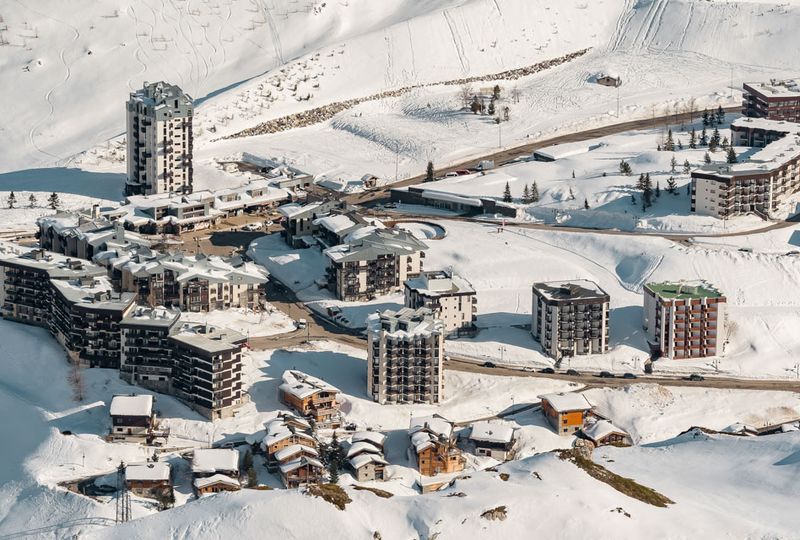 A bird's eye view of the purpose-build resort village of Tignes under snow